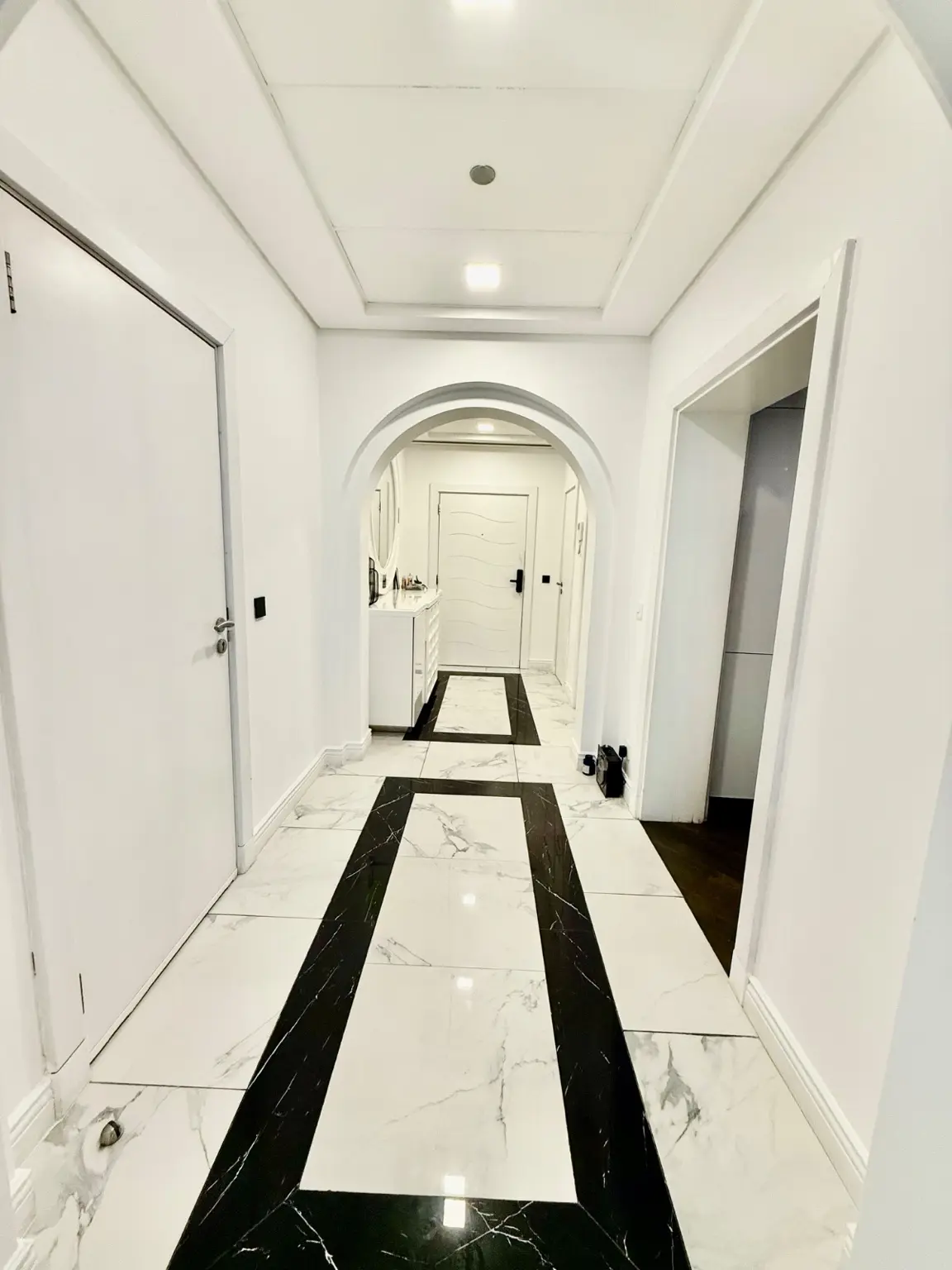 Renovated main entrance corridor with arched openings and graphic stone floor