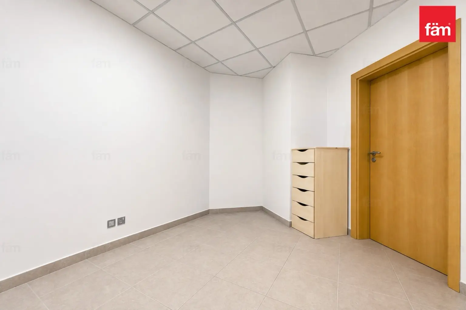 Original empty service room with plain walls and basic drawer unit